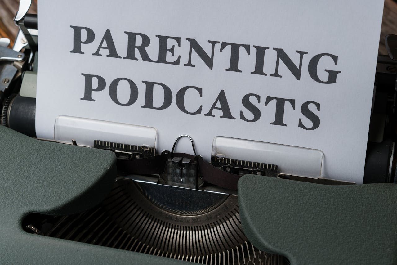 Close-up of a vintage typewriter with a sheet titled Parenting Podcasts.